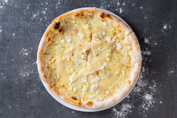 Freshly baked 4 Cheese Pizza with mozzarella and a rich blend of Italian cheeses, served at The Meet Up in Cascavelle, Mauritius.