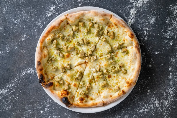 Freshly baked Chicken and Pesto Pizza with tender chicken, basil pesto, mozzarella and authentic Italian flavours, served at The Meet Up in Cascavelle, Mauritius.