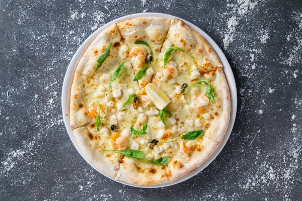 Freshly baked Frutti di Mare Pizza with premium seafood, mozzarella and authentic Italian flavours, served at The Meet Up in Cascavelle, Mauritius.