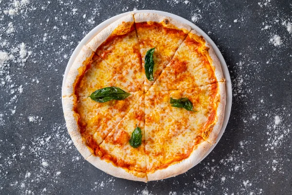 Freshly baked Pizza Margherita with tomato sauce, mozzarella, fresh basil and authentic Italian flavours, served at The Meet Up in Cascavelle, Mauritius.