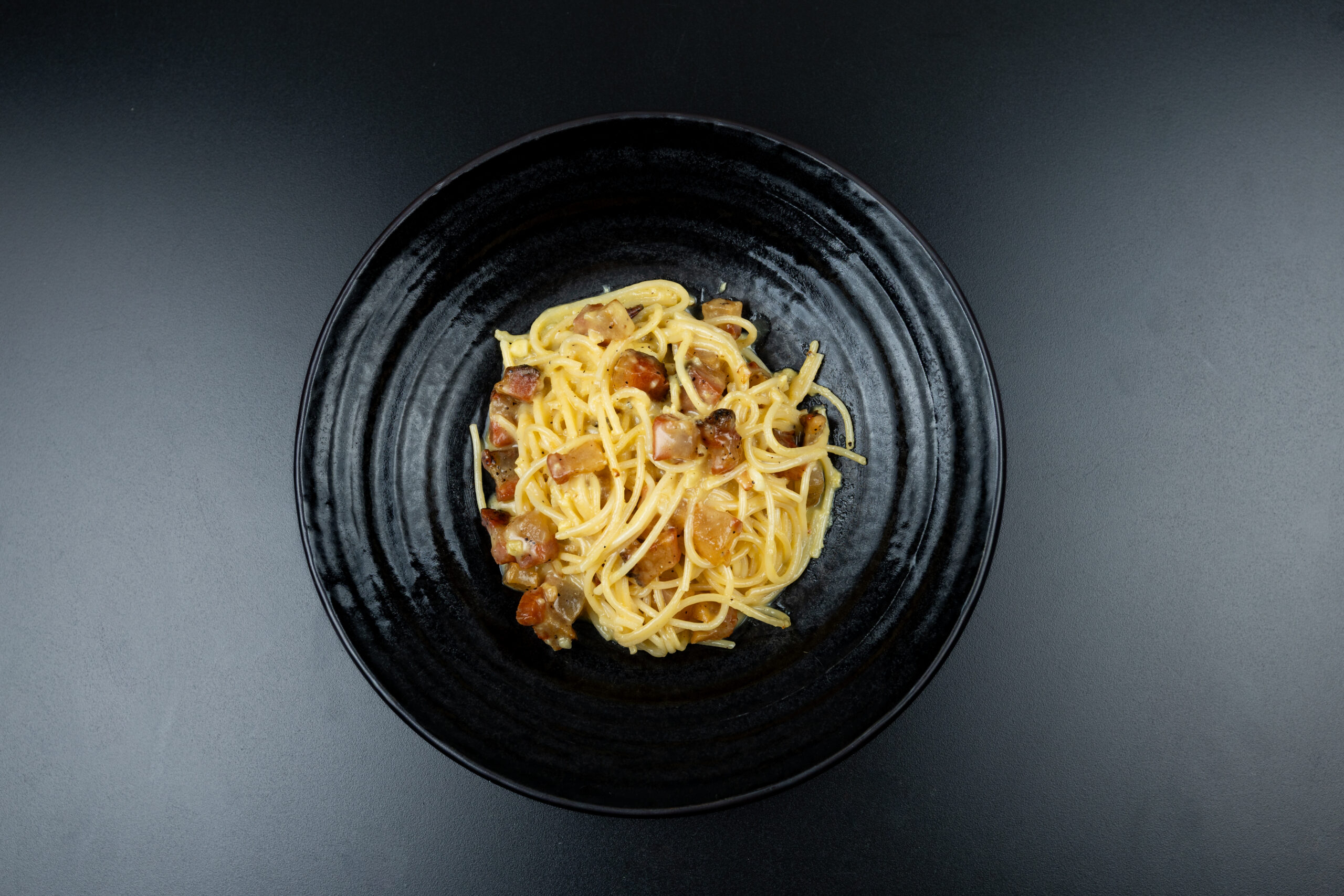 Traditional Spaghetti Carbonara with egg, Pecorino Romano cheese, guanciale and black pepper served at The Meet Up in Cascavelle, Mauritius.