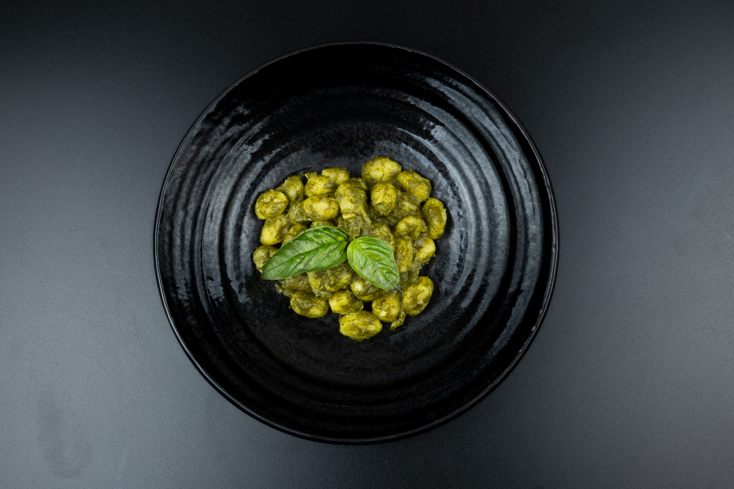 Soft potato gnocchi coated in aromatic basil pesto and Parmesan cheese, served at The Meet Up in Cascavelle, Mauritius.