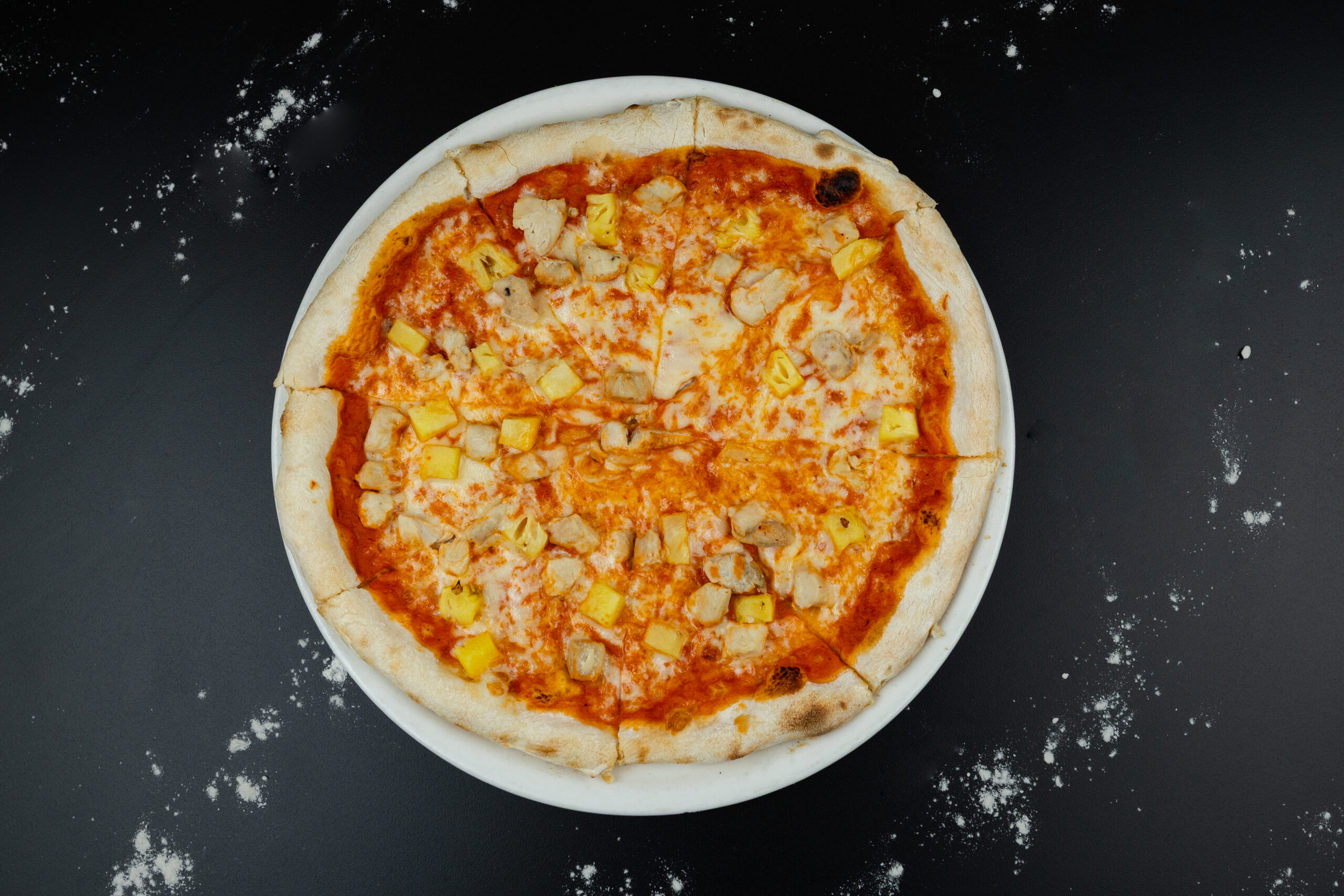 Freshly baked Hawaiian Pizza topped with ham, pineapple and mozzarella, served at The Meet Up in Cascavelle, Mauritius.